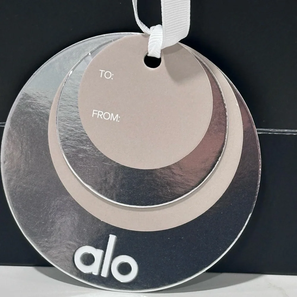 ALO black and white, empty paper bag with tissue paper and holiday gift charm. - Picture 3 of 5